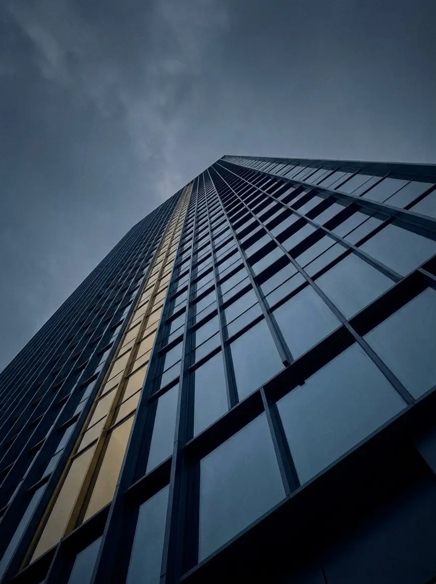 Upward view of a glass office tower facade in Hong Kong